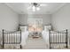 Inviting bedroom featuring two beds and a floral-painted table at 209 Democracy Pl, Apex, NC 27523