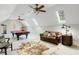 Large bonus room with pool table, comfortable seating, and multiple skylights at 209 Democracy Pl, Apex, NC 27523