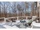 Outdoor deck with seating area and grill, ideal for gatherings and enjoying the surrounding wooded views at 209 Democracy Pl, Apex, NC 27523