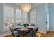 Charming dining area featuring hardwood floors, plantation shutters, and a unique decorative light fixture at 209 Democracy Pl, Apex, NC 27523