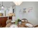 Cozy dining area with wood floors, decorative chandelier and views to kitchen at 209 Democracy Pl, Apex, NC 27523