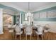 Dining area with a chandelier and decorative wall paneling is adjacent to the living room at 209 Democracy Pl, Apex, NC 27523