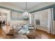 Elegant dining room featuring hardwood floors, plantation shutters, and stylish chandelier at 209 Democracy Pl, Apex, NC 27523