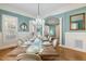 Open-concept dining area with view into the living room and an adjacent sitting area at 209 Democracy Pl, Apex, NC 27523