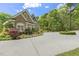 Beautiful brick home featuring manicured landscaping, a circular driveway, and classic architectural details at 209 Democracy Pl, Apex, NC 27523