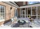 Rear exterior of the home with an outdoor deck, and access to screened porch at 209 Democracy Pl, Apex, NC 27523