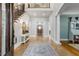 Elegant foyer with travertine floors, staircase, columns, and views to other rooms at 209 Democracy Pl, Apex, NC 27523