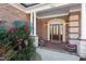 Charming front entrance with a brick facade, elegant columns, and a beautifully crafted front door at 209 Democracy Pl, Apex, NC 27523