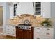 Kitchen features stainless steel range and hood with custom cabinets and granite countertops at 209 Democracy Pl, Apex, NC 27523