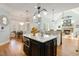 Spacious kitchen area with island, granite counters, stainless appliances, and nearby dining at 209 Democracy Pl, Apex, NC 27523