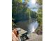 Serene lake view from a private dock, surrounded by lush greenery and sun-dappled water at 209 Democracy Pl, Apex, NC 27523