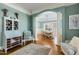 Charming living room leading to a dining area with architectural columns and hardwood floors at 209 Democracy Pl, Apex, NC 27523