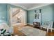Comfortable living room with wood floors, statement columns and staircase views at 209 Democracy Pl, Apex, NC 27523