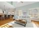 Open-concept living room boasts vaulted ceilings, plantation shutters, and seamless flow to the kitchen at 209 Democracy Pl, Apex, NC 27523