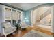 Inviting living room with large windows, hardwood floors, and classic architectural details at 209 Democracy Pl, Apex, NC 27523