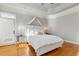 Bright main bedroom boasts hardwood floors, a tray ceiling, and stylish bedside tables with elegant lamps at 209 Democracy Pl, Apex, NC 27523