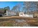 Expansive back yard with a two story home and an outbuilding, all with white exteriors at 226 Riverforest Dr, Hillsborough, NC 27278