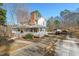 Traditional two-story home with a full front porch, a brick chimney, and a two car carport at 226 Riverforest Dr, Hillsborough, NC 27278