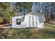 View of white outbuilding with double barn doors, small window and overhanging roof at 226 Riverforest Dr, Hillsborough, NC 27278