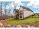 Expansive backyard features a lush lawn, wood-look deck, and wooded view, perfect for outdoor relaxation at 227 Beech Slope Ct, Chapel Hill, NC 27517