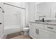 Modern bathroom features a tiled shower, a white vanity, and black fixtures at 227 Beech Slope Ct, Chapel Hill, NC 27517