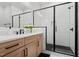 Stylish bathroom with a modern vanity, black fixtures, and a glass-enclosed shower with black accents at 227 Beech Slope Ct, Chapel Hill, NC 27517