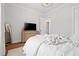 Cozy bedroom with a dresser and television, hardwood floors, and a soft, inviting bedspread at 227 Beech Slope Ct, Chapel Hill, NC 27517