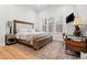 Bright bedroom features a large bed, a rustic rug, and a home office setup at 227 Beech Slope Ct, Chapel Hill, NC 27517