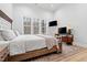 Bright bedroom features a large bed, a rustic rug, and a home office setup at 227 Beech Slope Ct, Chapel Hill, NC 27517