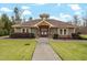 Exterior shot of the clubhouse, showcasing its welcoming entrance, stone accents, and landscaped surroundings at 227 Beech Slope Ct, Chapel Hill, NC 27517