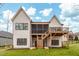 Rear exterior featuring multiple decks and a spacious backyard at 227 Beech Slope Ct, Chapel Hill, NC 27517