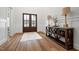 Bright foyer with wood floors, paneled walls, wooden double doors and an elegant console table at 227 Beech Slope Ct, Chapel Hill, NC 27517