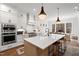 Bright kitchen with white cabinets, large island and stainless steel appliances at 227 Beech Slope Ct, Chapel Hill, NC 27517