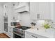 Modern kitchen with white cabinets, stainless steel appliances and gas cooktop at 227 Beech Slope Ct, Chapel Hill, NC 27517