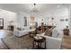 Spacious living room open to the kitchen featuring wood floors and modern lighting at 227 Beech Slope Ct, Chapel Hill, NC 27517