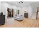 Bright living room with wood floors, staircase, and sliding doors leading to an outdoor deck at 227 Beech Slope Ct, Chapel Hill, NC 27517