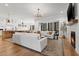 Open living room featuring white couches, fireplace, wood floors and modern chandelier at 227 Beech Slope Ct, Chapel Hill, NC 27517