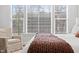 Bedroom with a large window and a comfortable chair at 227 Beech Slope Ct, Chapel Hill, NC 27517