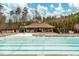 Large community pool with a splash pad, picnic tables, lounge chairs, and grilling area for outdoor enjoyment at 227 Beech Slope Ct, Chapel Hill, NC 27517