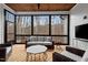 Screened porch with outdoor furniture and ceiling fan overlooking trees at 227 Beech Slope Ct, Chapel Hill, NC 27517