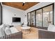 Covered porch with outdoor seating area and a TV with sliding door to living space at 227 Beech Slope Ct, Chapel Hill, NC 27517