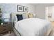 Well-lit bedroom with a large bed, wallpapered accent wall, and modern furniture at 268 Moyer Dr, Graham, NC 27253