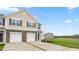 Charming two-story townhome featuring a stone facade, two-car garage, and well-manicured lawn at 268 Moyer Dr, Graham, NC 27253