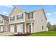 Attractive townhome with stone accents, a welcoming entryway, and a well-maintained green space at 268 Moyer Dr, Graham, NC 27253