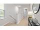 Hallway with carpet floors, glass table, and a large mirror hanging on the wall at 268 Moyer Dr, Graham, NC 27253