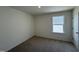 Cozy bedroom with a window providing natural light and neutral carpet at 2701 Princess Tree Dr, Raleigh, NC 27616