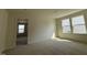 Well-lit bedroom featuring neutral carpeting, and natural light from the windows creating a cozy atmosphere at 2701 Princess Tree Dr, Raleigh, NC 27616
