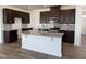 Modern kitchen featuring an island with granite countertops, stainless steel appliances, and elegant wooden cabinetry at 2701 Princess Tree Dr, Raleigh, NC 27616