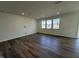 Bright living room with hardwood floors and multiple windows, perfect for entertaining and relaxation at 2701 Princess Tree Dr, Raleigh, NC 27616