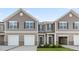Charming townhouses feature gray siding, white trim, shutters, and attached garages at 272 Moyer Dr, Graham, NC 27253